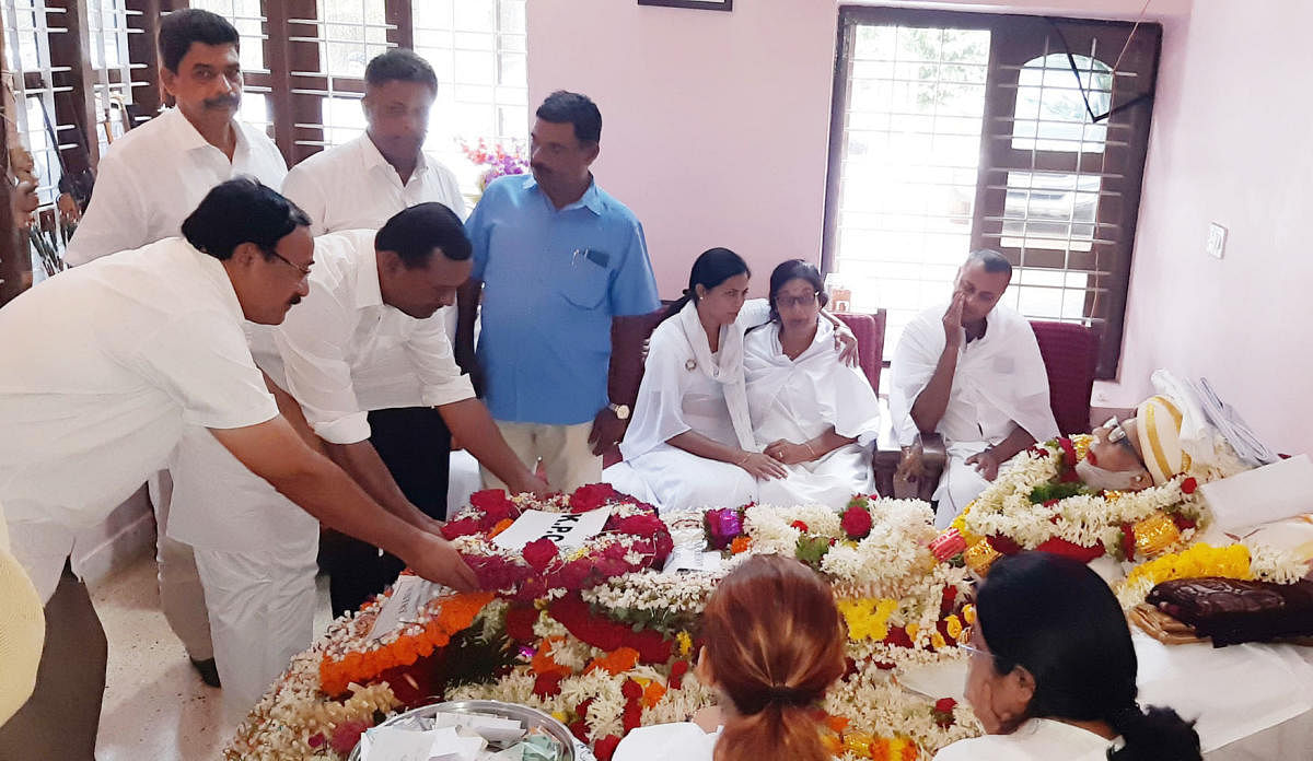People pay homage to A K Subbaiah's mortal remains at his residence in Kallugundi coffee estate in Belluru near Gonikoppa on Wednesday.