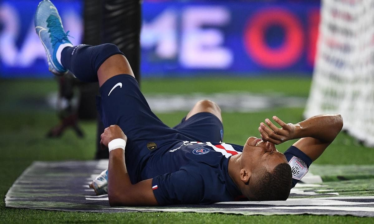Paris Saint-Germain's French forward Kylian Mbappe reacts following an injury during the French L1 football match between Paris Saint-Germain (PSG). (AFP Photo)