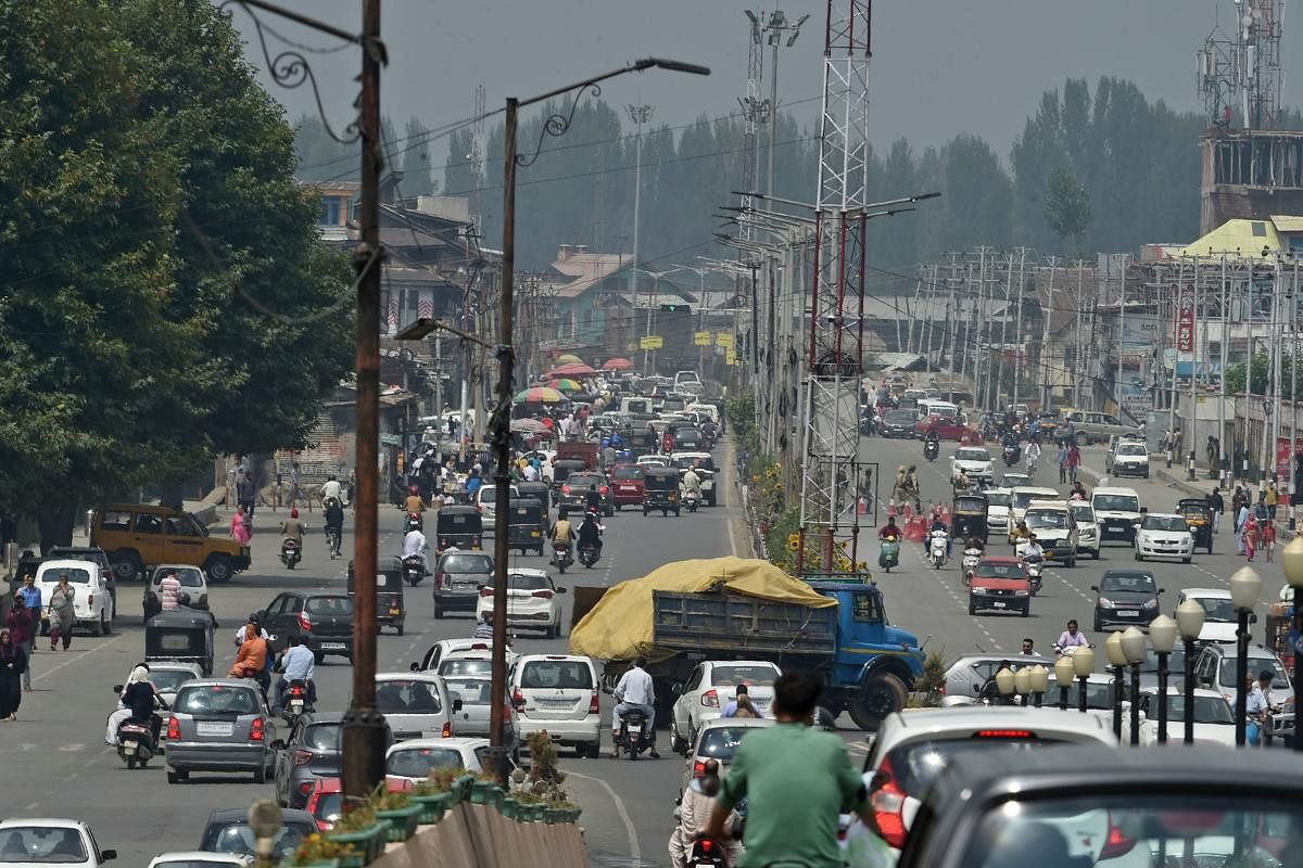 Residents drive along a busy road in Srinagar. AFP file photo