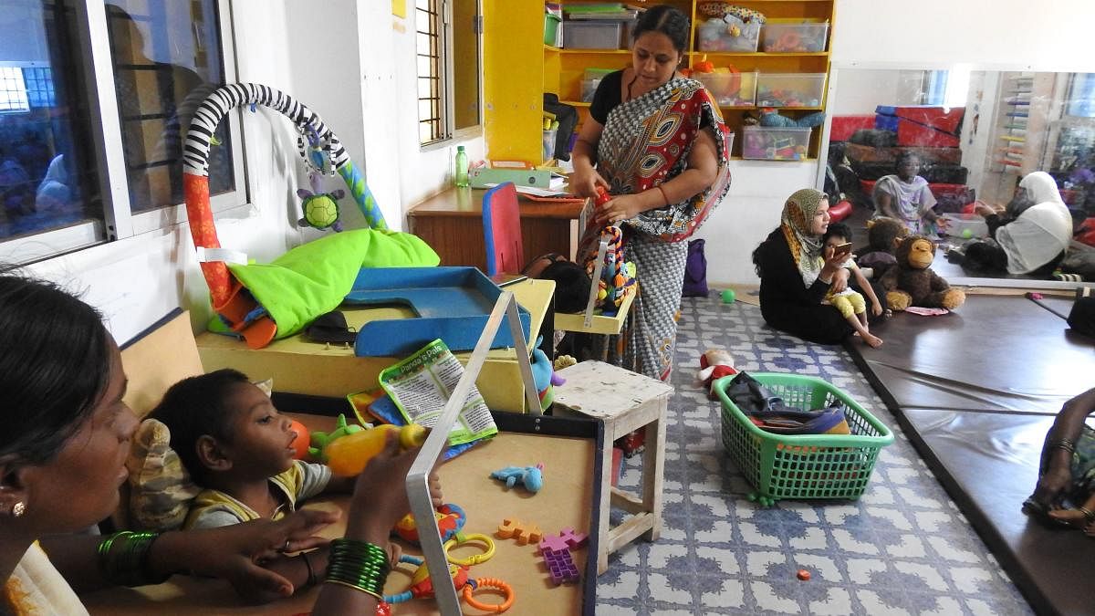 Teachers and parents attend to children at Samarthya, an early intervention centre for the differently-abled, in Koppal.
