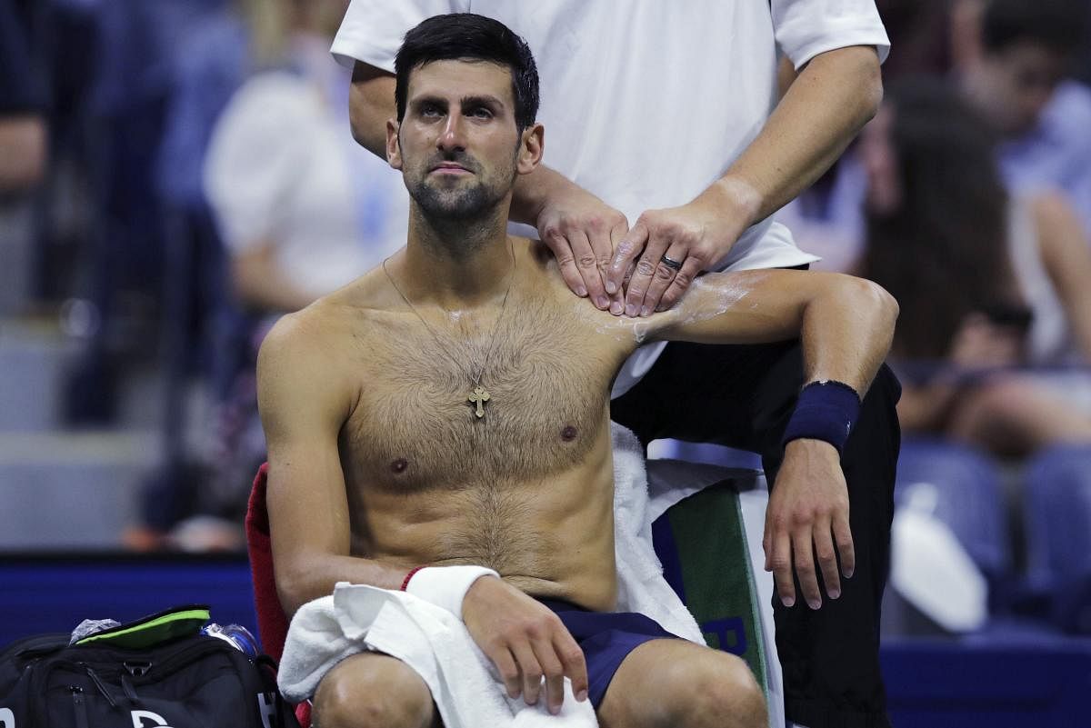 Novak Djokovic receives treatment from a trainer during his match against Argentina's Juan Ignacio Londero during the second round of the US Open (AP/PTI Photo)
