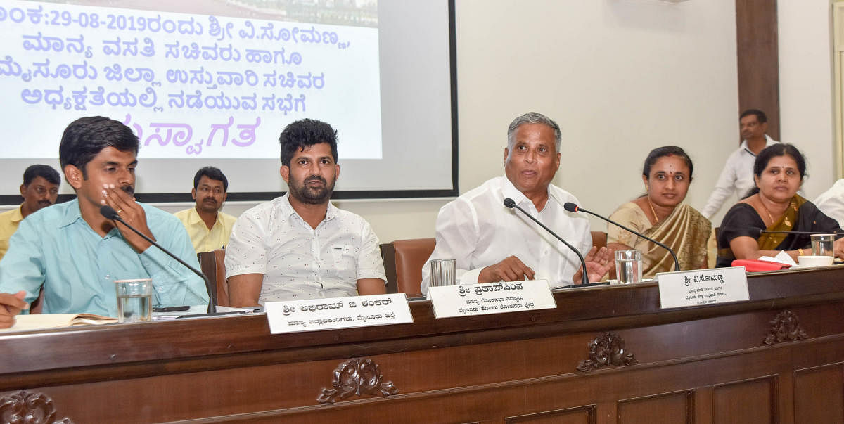 District in-charge Minister V Somanna addresses district-level officials during Dasara-related meeting at Zilla Panchayat in Mysuru on Thursday. Deputy Commissioner Abhiram G Sankar, MP Pratap Simha, ZP President Parimala Shyam and vice president M V Gowr
