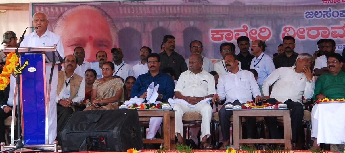 Chief Minister B S Yediyurappa speaks at a programme, after offering bagina, at KRS dam, in Srirangapatna taluk, Mandya district, on Thursday.