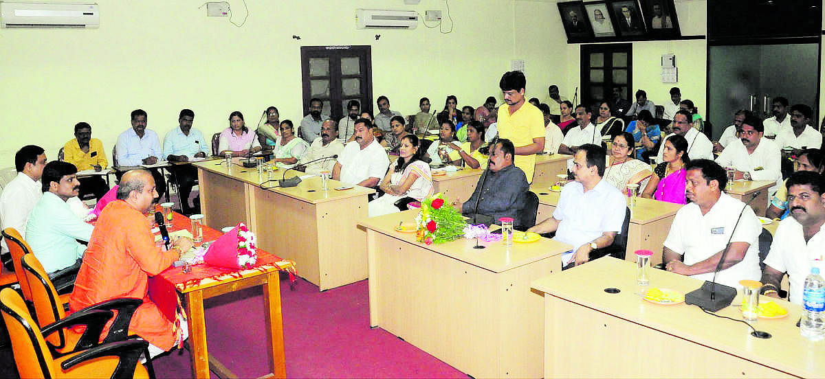 Udupi MLA Raghupathi Bhat speaks to officials and members of 35 wards in Udupi City Municipal Council (CMC) during a meeting held at Deputy Commissioner’s office in Manipal on Thursday. Deputy Commissioner G Jagadeesha and others look on.