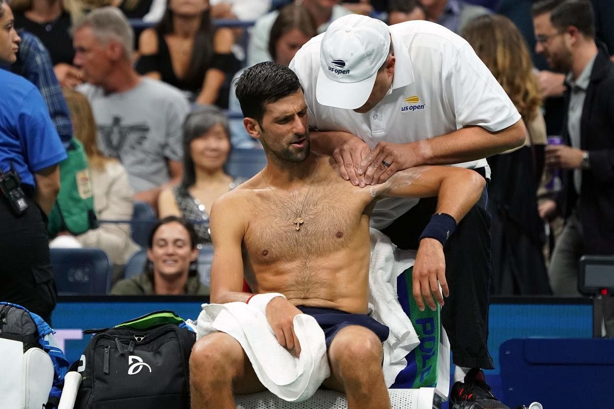 Novak Djokovic of Serbia receives treatment between games against Juan Ignacio Londero of Argentina during their Round Two Men's Singles match at the 2019 US Open. Photo/AFP