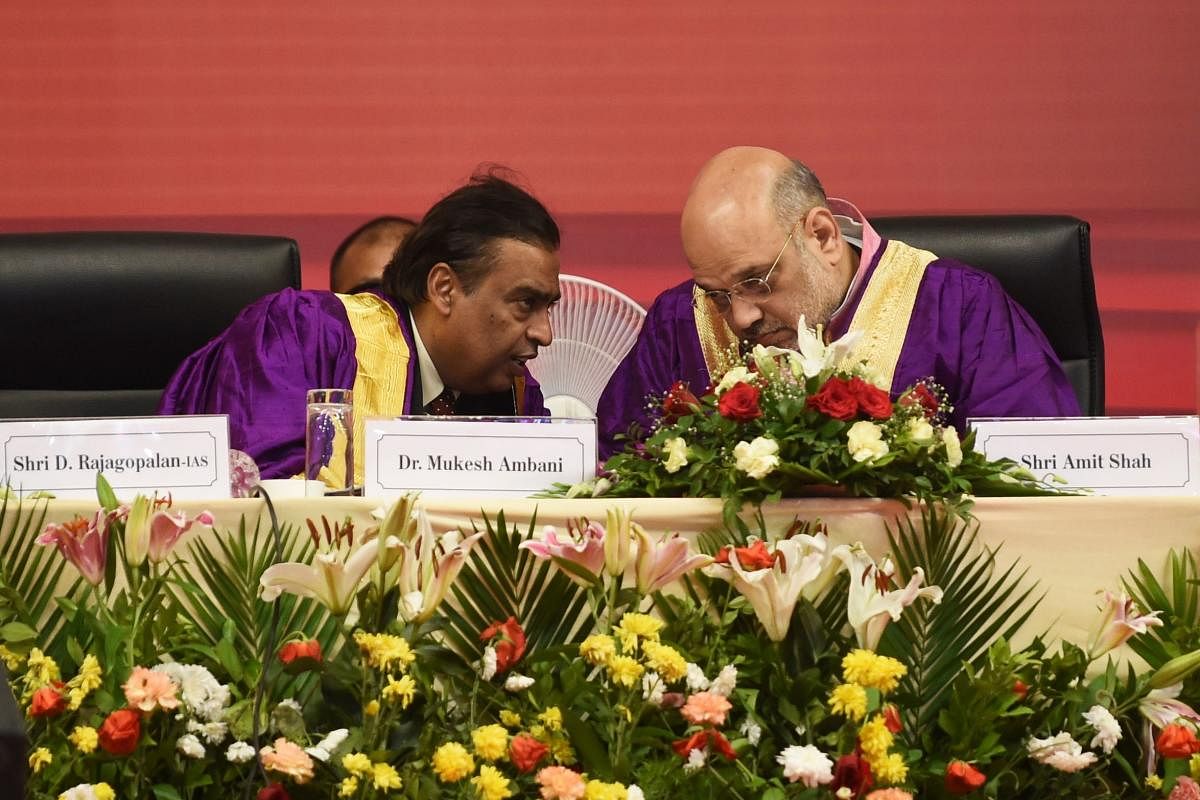 Home Minister Amit Shah and chairman of Pandit Dindayal Petroleum University and businessman Mukesh Ambani (L) during 7th Convocation Ceremony at the PDPU campus in Gandhinagar on Thursday. AFP