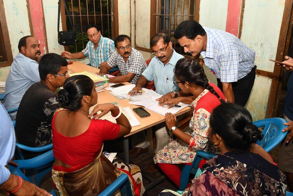 Workers at the National Register of Citizens (NRC) office check documents submitted by people for the NRC ahead of the release of the register's final draft in Guwahati. (AFP Photo)