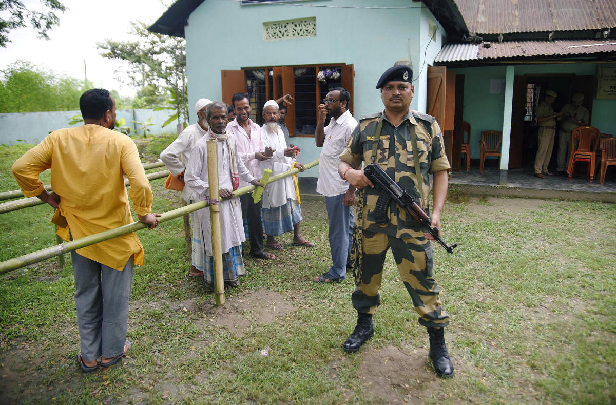 People stand in a queue to check their names on the draft list of the National Register of Citizens (NRC) outside an NRC centre in Rupohi village, Nagaon district, northeastern state of Assam. (Reuters photo)