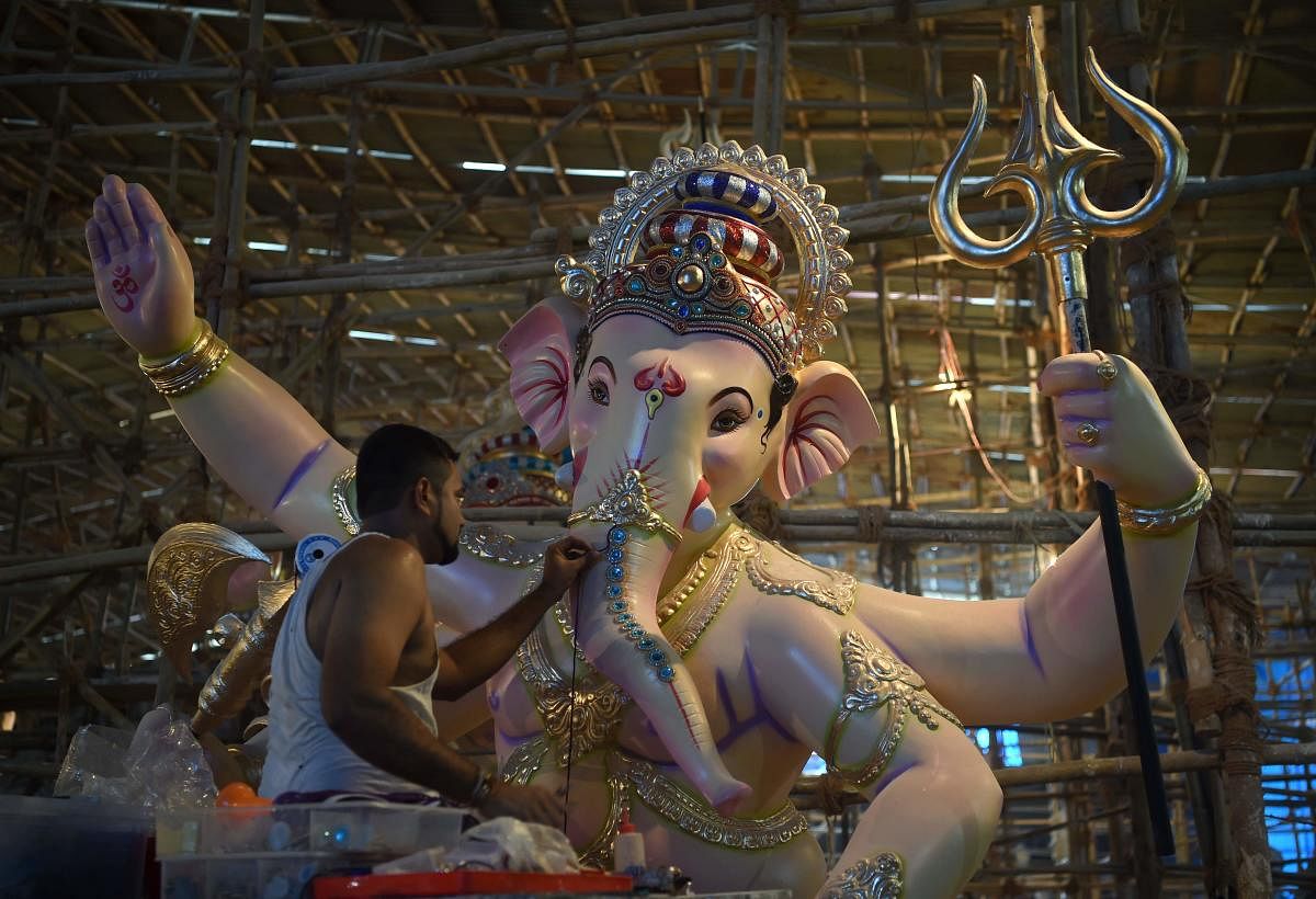 An artisan works on an idol of the elephant-headed Hindu god Lord Ganesha at a workshop ahead of the Ganesh Chaturthi festival in Mumbai. AFP photo