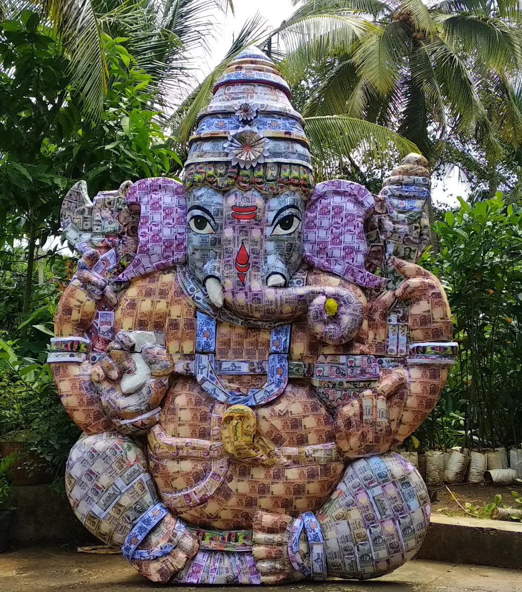 A Ganesha idol made from artificial currencies of 21 countries displayed at Sai Radha Motors on Vidya Samudra Road, Udupi.