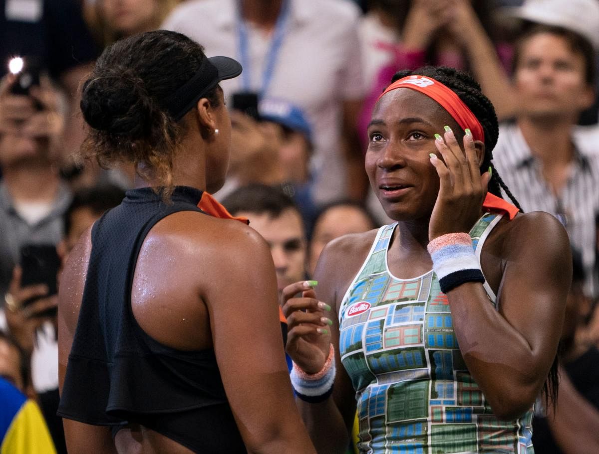 Naomi Osaka (L) of Japan comforts Coco Gauff of the US after the former thrashed her opponent in a third-round match. AFP Photo