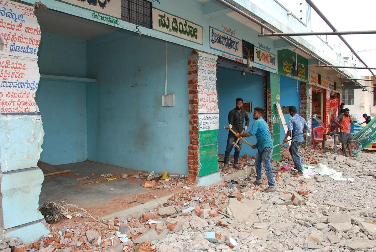 Owners of a few buildings voluntarily demolished the structures for the widening of Bengaluru-Mysuru highway into a 10-lane highway at Halebudanuru in Mandya district.