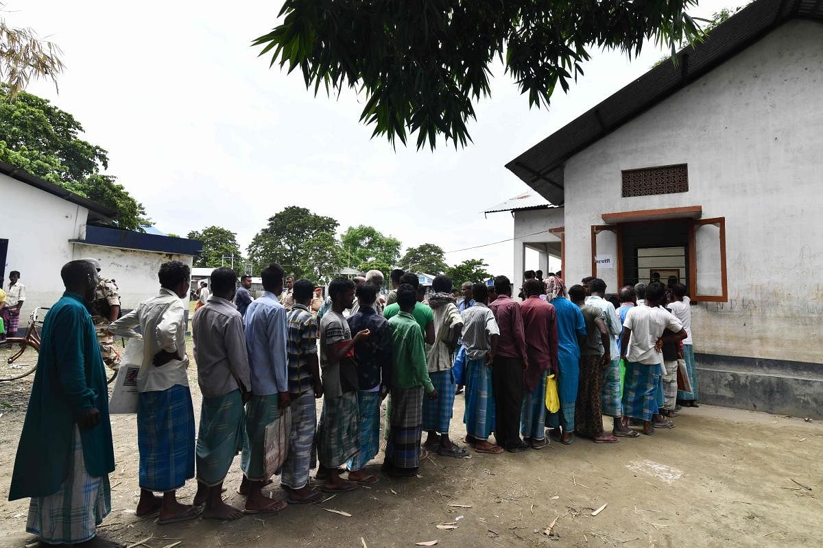 People stand in a queue to check their names on the final list of the National Register of Citizens (NRC) in an office in Pavakati village of Morigoan district, Assam. AFP file photo