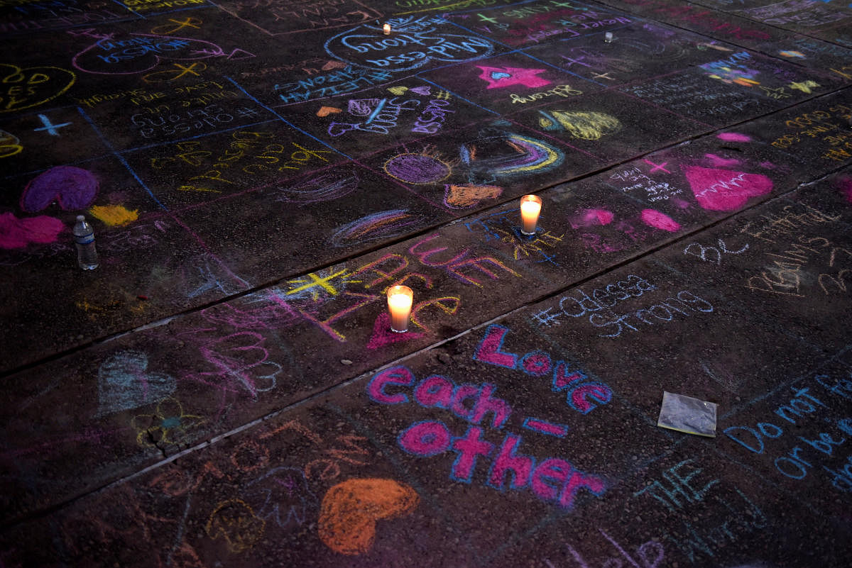 Messages written in sidewalk chalk are seen as people gather for a vigil following Saturday's shooting in Odessa, Texas, U.S. September 1, 2019. (REUTERS)