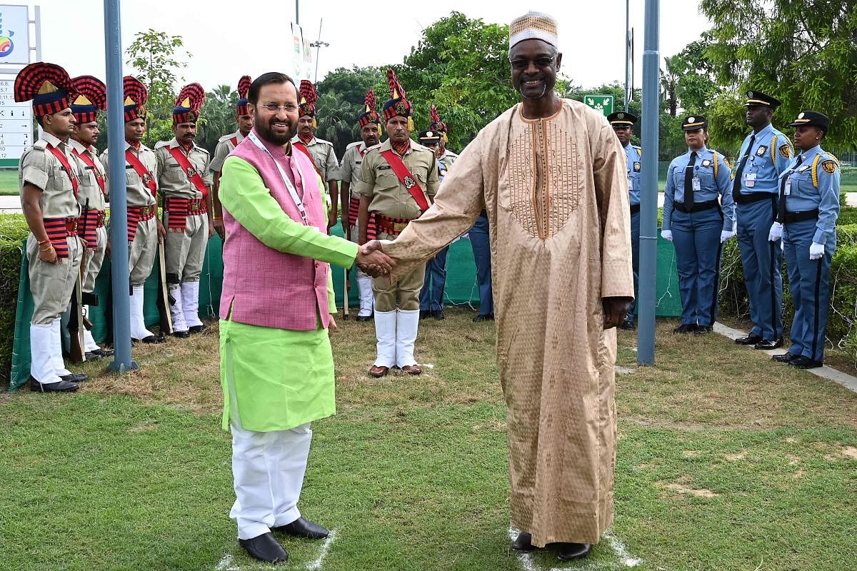 Ibrahim Thiaw (R), executive secretary of the United Nations Convention to Combat Desertification (UNCCD) and Prakash Javadekar, Indian minister of Environment, Forest and Climate Change shake hands after the flag hosting ceremony during the 14th meeting