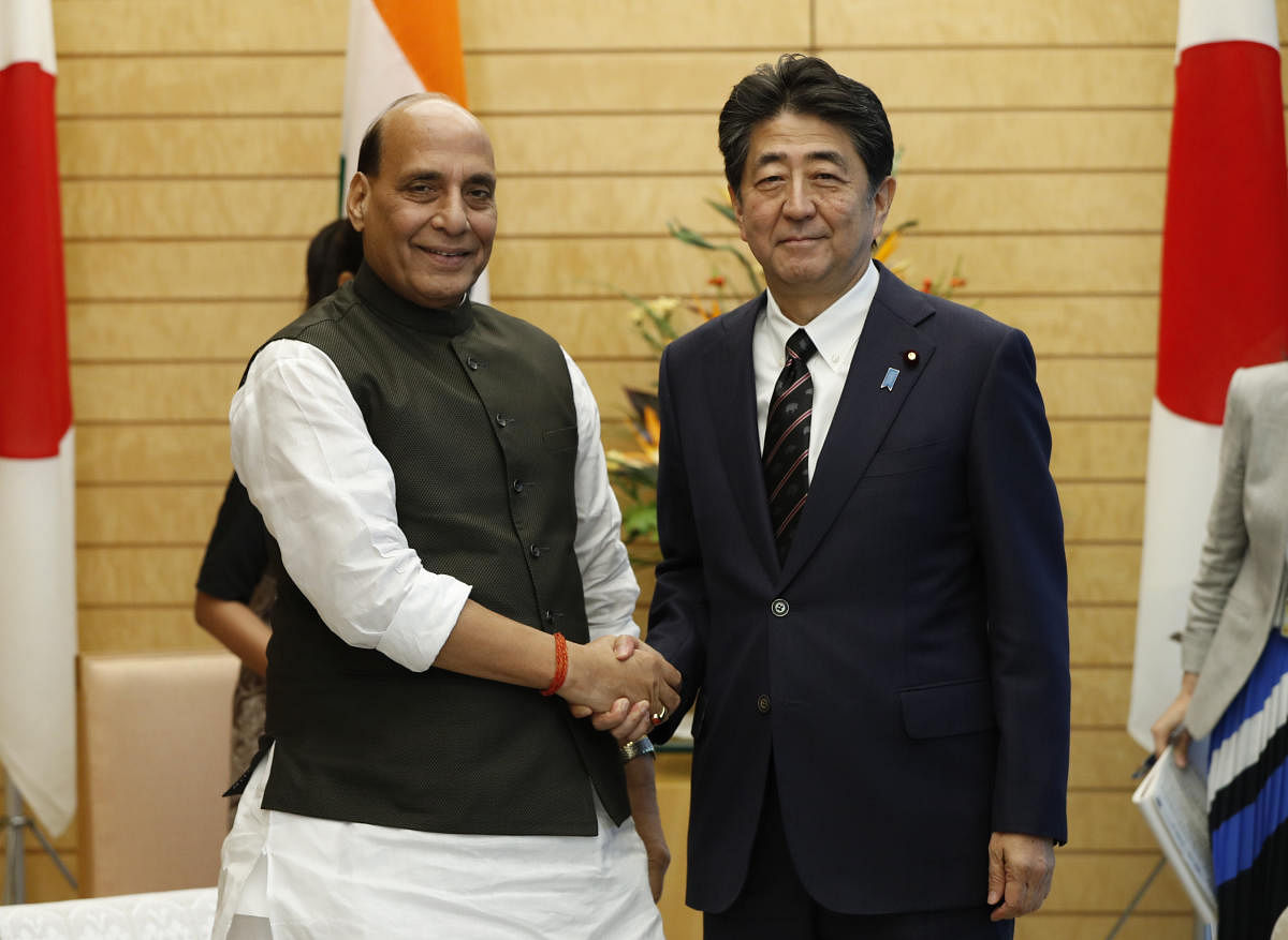 Defence Minister Rajnath Singh shakes hands with Japanese PM Shinzo Abe during a meeting at Abe's official residence in Tokyo. (AFP photo)