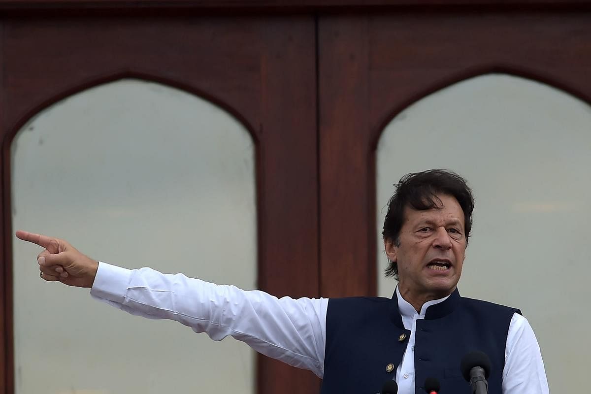 Pakistan's Prime Minister Imran Khan addresses the nation outside the Prime Minister Secretariat building in Islamabad. (Photo by AFP)