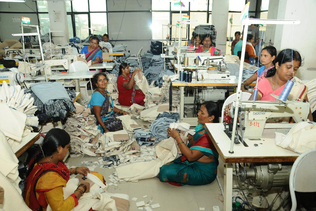 Workers stitching denim fabric at a jeans readymade garments manufacturing unit in Ballari.