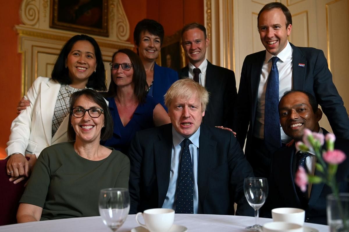 Britain's Prime Minister Boris Johnson (C) and Britain's Health and Social Care Secretary Matt Hancock (2R) pose with NHS workers inside 10 Downing Street in central London on September 3, 2019. (Photo by AFP)