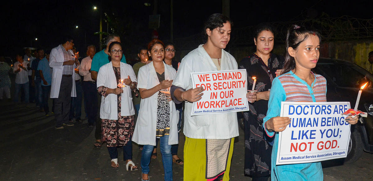 Assam Medical College &amp; Hospital Teachers Association and the Assam wing of the Indian Medical Association (IMA) take out a candle protest rally against the alleged assault on a senior doctor Deben Dutta (73), in Dibrugarh. PTI photo