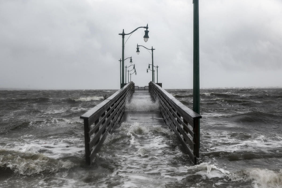 Strong gusts of wind and bands of heavy rain cover a walkway at the Jensen Beach Causeway Park in Jensen Beach, Florida. (AFP Photo)