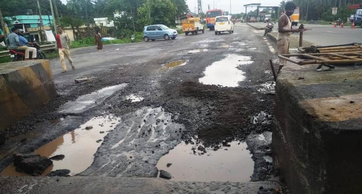 A view of the pothole filled highway near Brahmarakootlu toll plaza. DH Photo