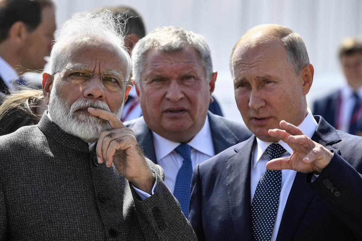 Russian President Vladimir Putin, right, and Indian Prime Minister Narendra Modi, left, talk to each other as they visit shipyard Zvezda. (AP/PTI photo)