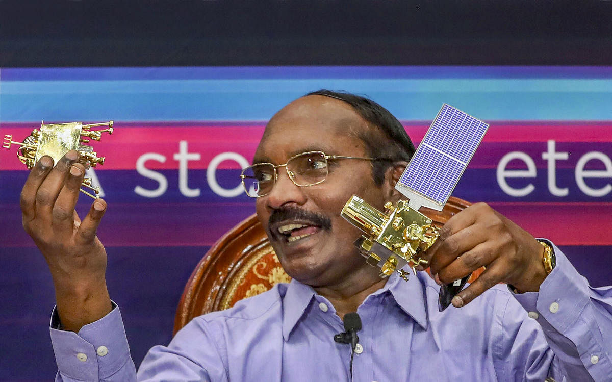 ISRO Chairman K Sivan displays a model of Chanrayaan-2 orbiter and rover during a press conference in Bengaluru. PTI file photo