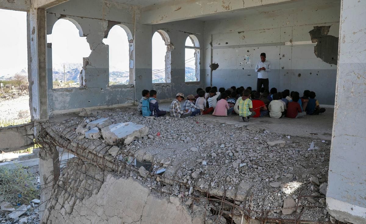 Yemeni children attend class on the first day of the new academic year in the country's third-city of Taez on September 3, 2019, at a school that was damaged last year in an air strike. AFP Photo