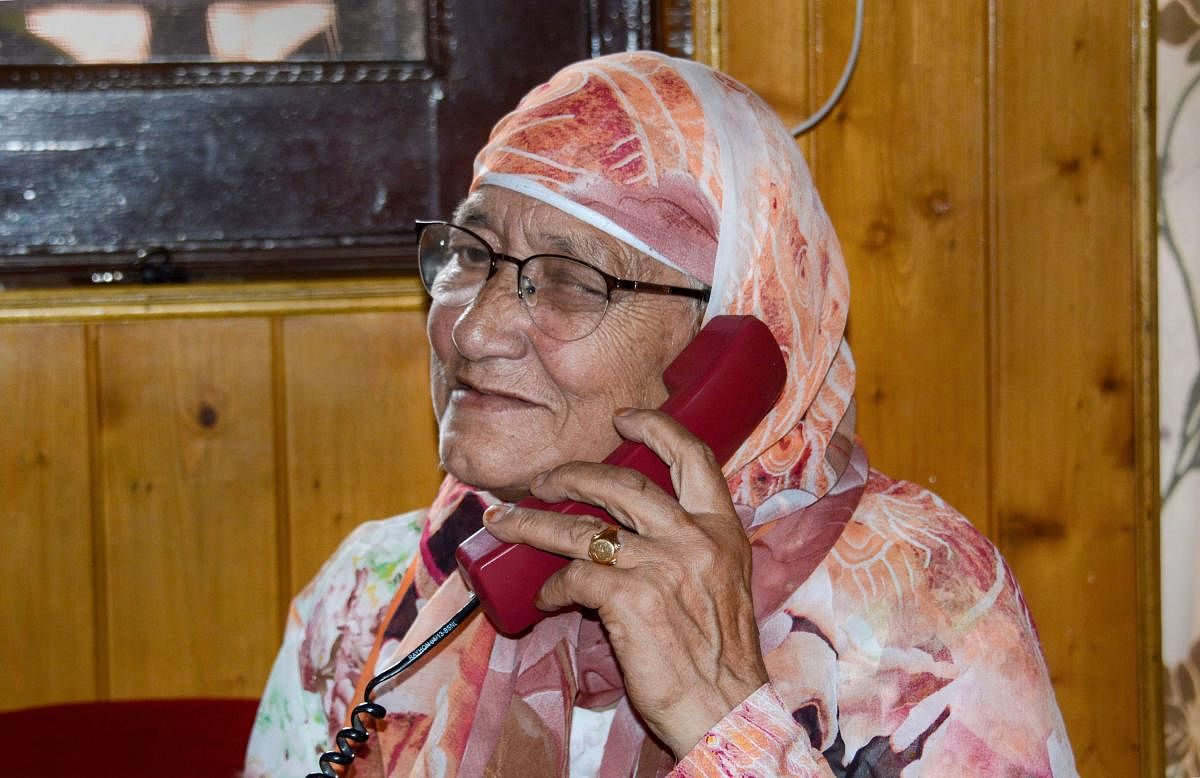  An elderly resident talks on phone after authorities in Kashmir restored 19 more telephone exchanges, a month after telephone services were snapped following abrogation of provisions of Article 370, in Srinagar, Thursday, Sept 5, 2019. (PTI Photo)