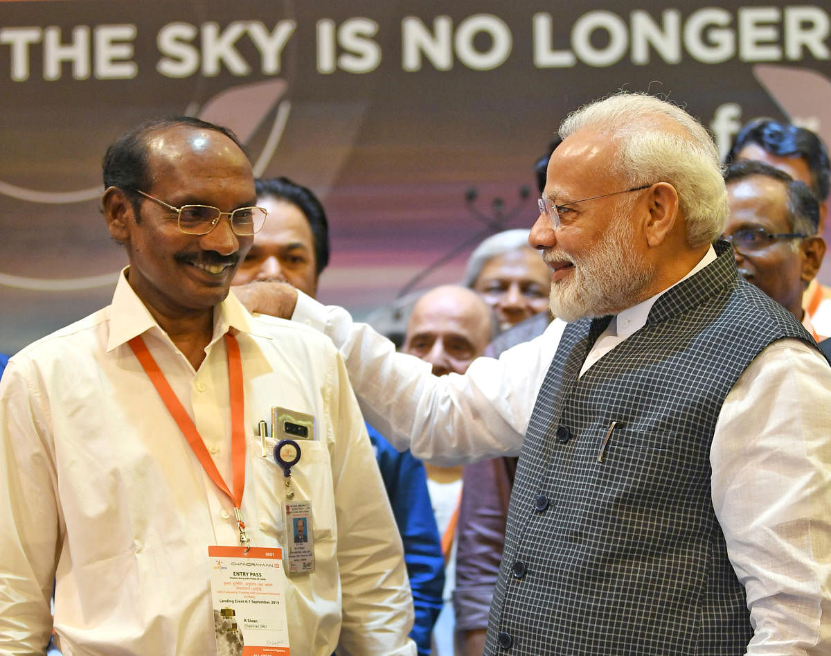 Prime Minister Narendra Modi talks to ISRO chief K Sivan in Bengaluru. (Reuters Photo)
