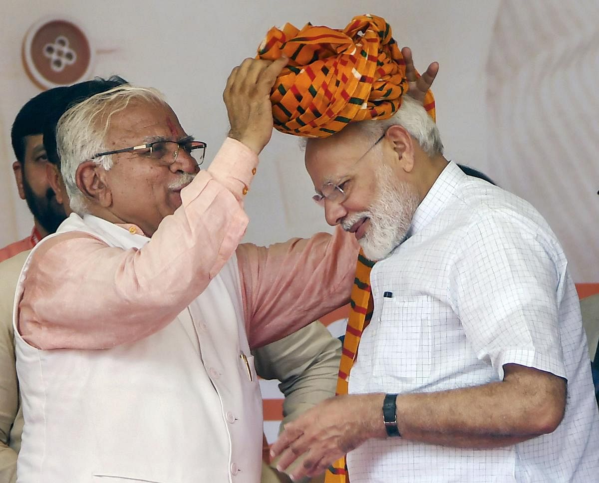 Rohtak: Prime Minister Narendra Modi is presented a turban by Haryana Chief Minister Manohar Lal Khattar during a public rally, in Rohtak, Sunday, Sept 8, 2019. (PTI Photo)