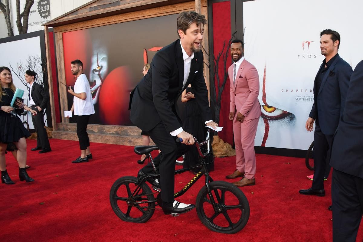 Andy Muschietti rides a bicycle on the red carpet during the World premiere of "It Chapter Two" at the Regency Village theatre in Westwood, California. (Photo by AFP)