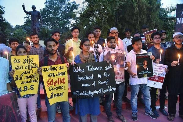People take out a candle light march as they hold placards to protest against the death of 24-year-old Tabrez Ansari due to mob lynching, in Patna. (Photo/PTI))