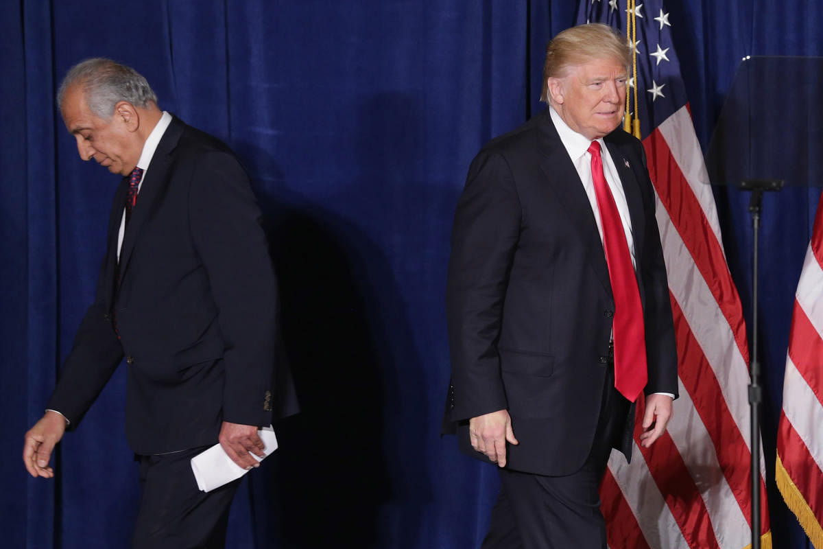(FILES) In this file photo taken on April 27, 2016 Republican presidential candidate Donald Trump (R) takes the stage after being introduced by former U.S. Ambassador to Iraq and Afghanistan Zalmay Khalilzad at the Mayflower Hotel in Washington, DC. - US