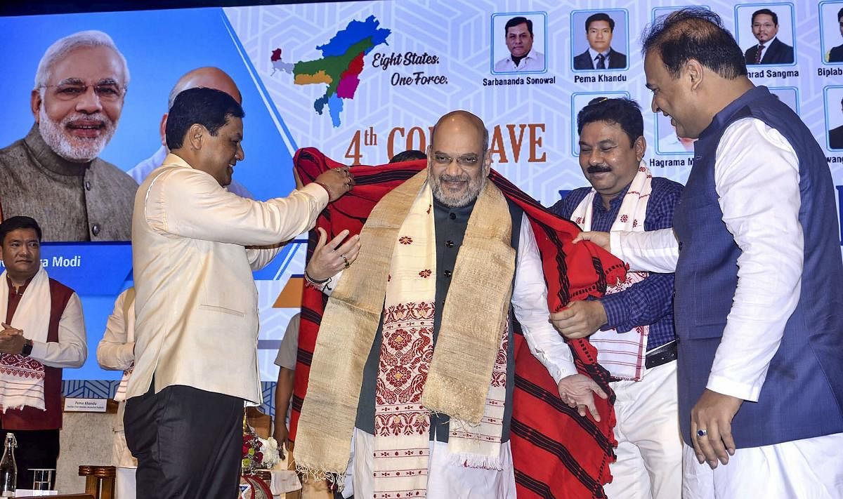 Guwahati: Union Home Minister Amit Shah being feliciated by Assam Chief Minister Sarbananda Sonowal during the 4th Conclave of the North East Democratic Alliance (NEDA), in Guwahati, Monday, Sept 9, 2019. (PTI Photo) (PTI9_9_2019_000075B)