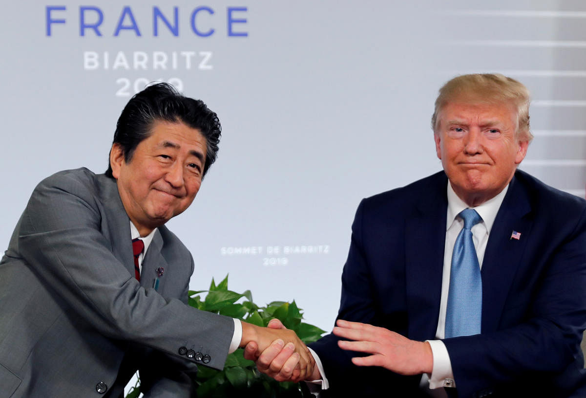 US President Donald Trump and Japan's Prime Minister Shinzo Abe shake hands at a bilateral meeting during the G7 summit in Biarritz, France. Reuters File Photo