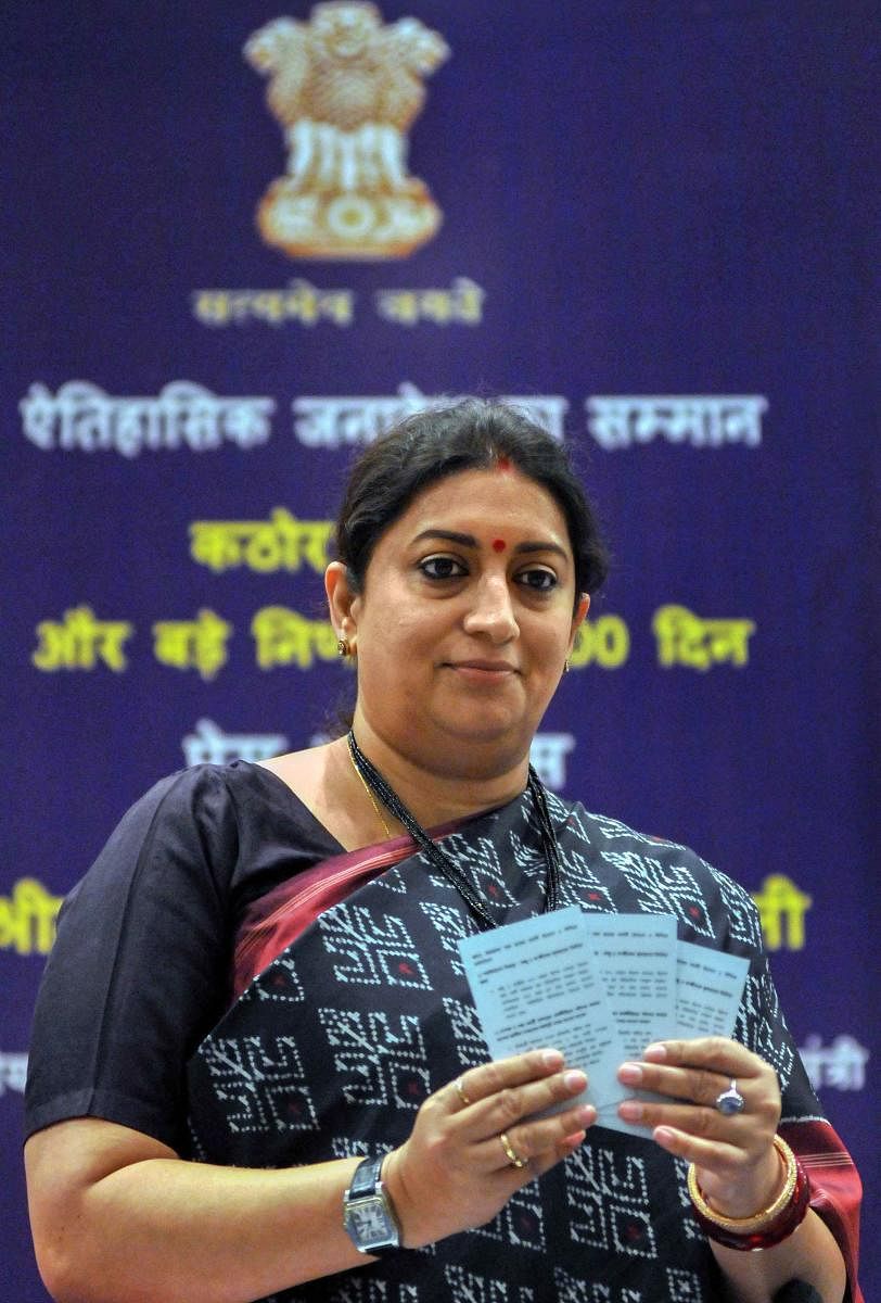Union Minister for Women and Child Development, and Textiles Smriti Irani launches booklets at a press conference on completion of 100 days by the NDA government 2, at New Town on the outskirts of Kolkata. PTI