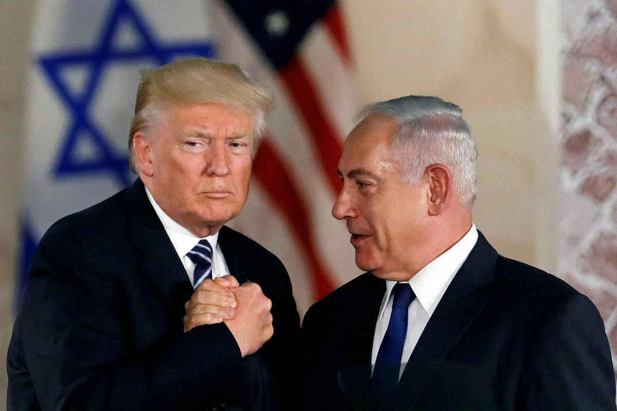FILE PHOTO: U.S. President Donald Trump and Israeli Prime Minister Benjamin Netanyahu shake hands after Trump's address at the Israel Museum in Jerusalem May 23, 2017. REUTERS/Ronen Zvulun/File Photo