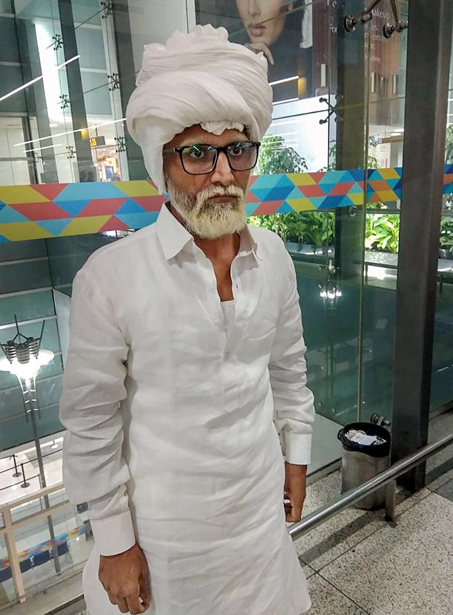Jayesh Patel (32) an Ahmedabad resident, who allegedly impersonated an octogenarian passenger by using a fake passport, at Delhi airport. PTI Photo