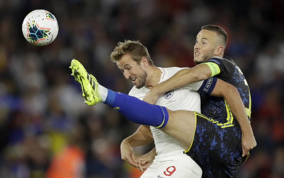 England's Harry Kane, left, and Kosovo's Amir Rrahmani challenge for the ball during the Euro 2020 group A qualifying match. PTI/AP Photo