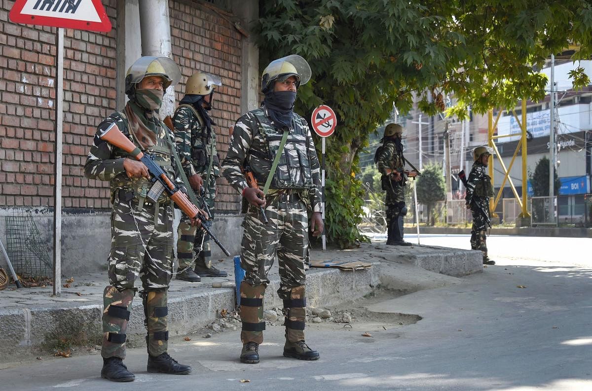 Srinagar: Security personnel stand guard during curfew like restrictions in Srinagar. (PTI Photo)