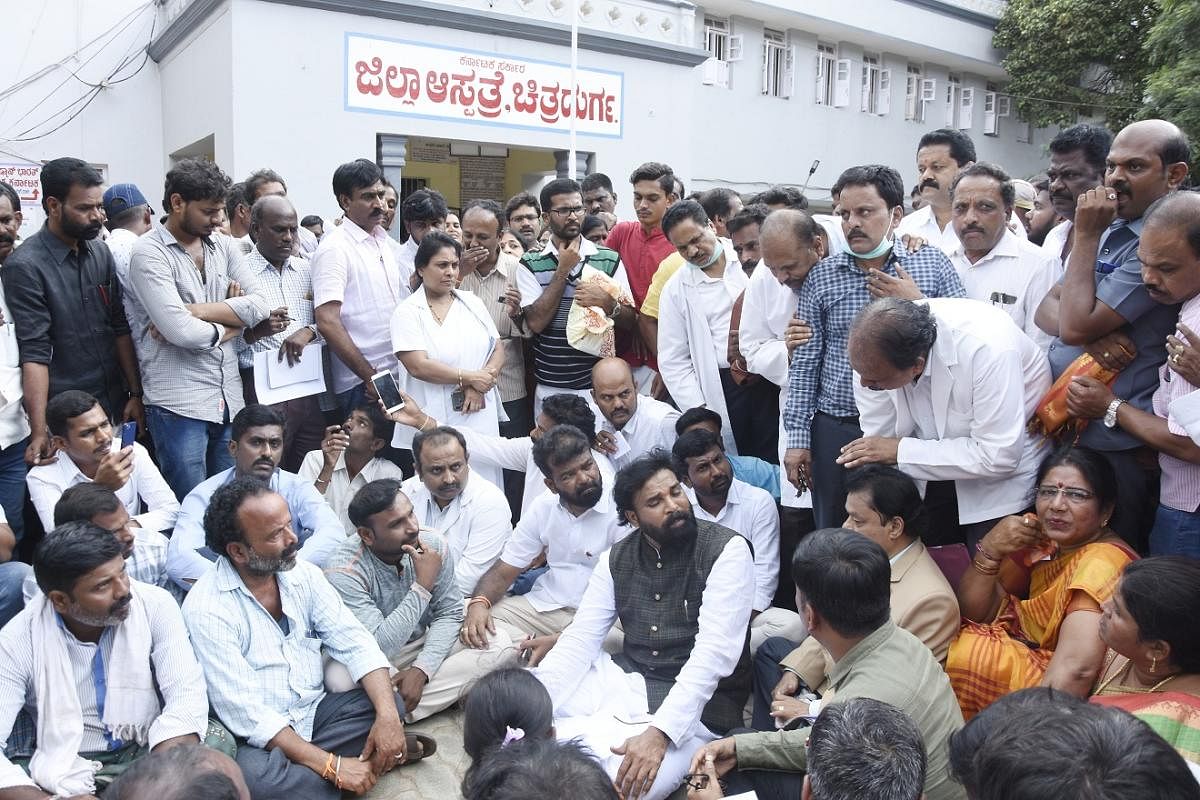 Health Minister B Sreeramulu listens to patients' woes outside the Chitradurga District Hospital, in Chitradurga on Wednesday. DH Photo.