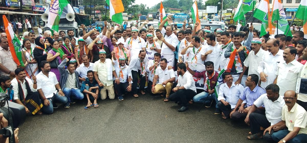 Bantwal and Panemangalore Block Congress Committee members stage a protest against pathetic condition of National Highway at B C Road on Wednesday.