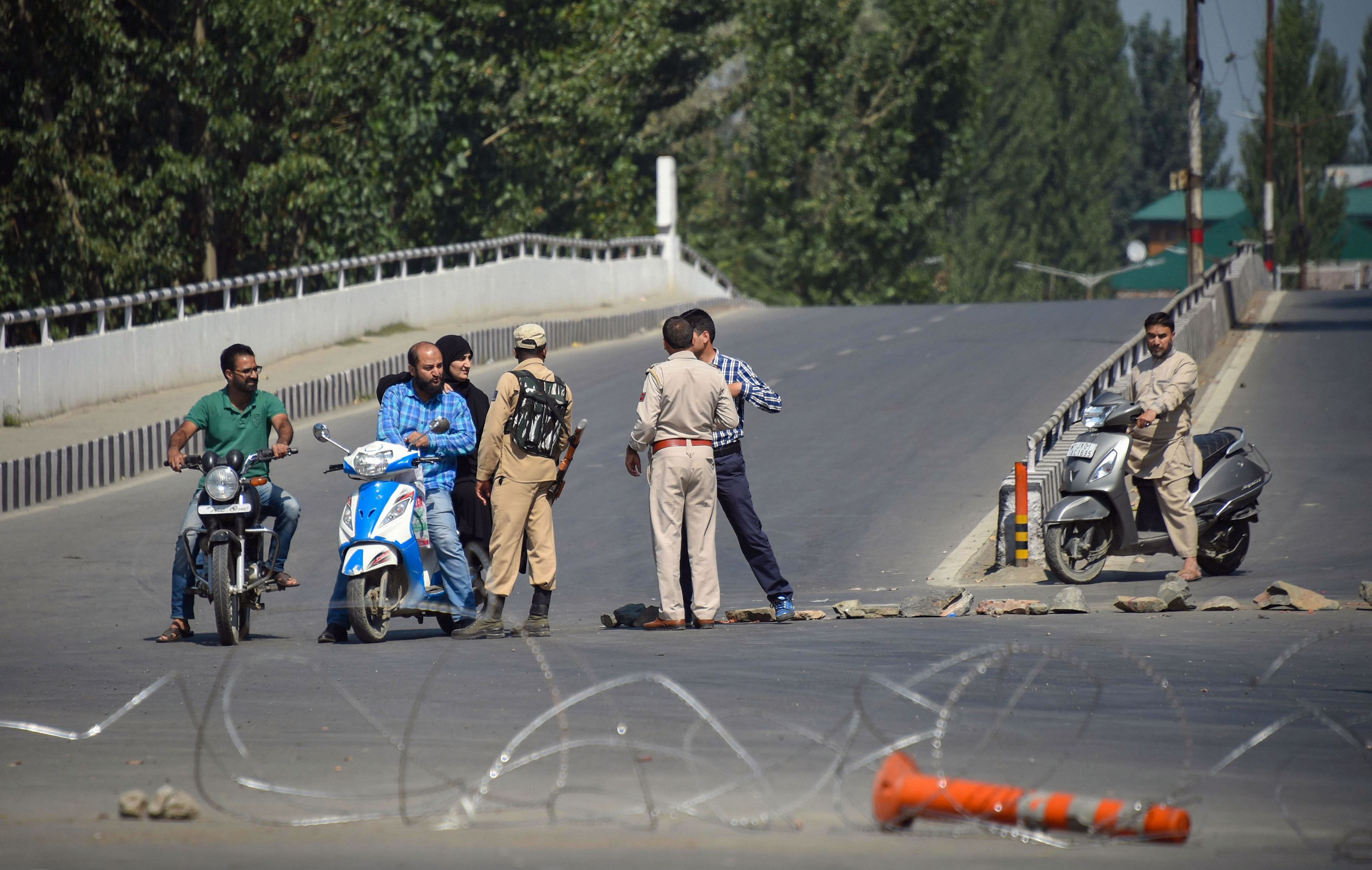 Srinagar: Security personnel stop two wheelers for checking during curfew like restrictions in Srinagar. (PTI Photo)