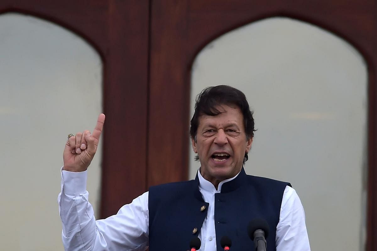 Pakistan's Prime Minister Imran Khan speaks during a rally in Muzaffarabad on September 13, 2019. - Pakistani prime minister Imran Khan branded his Indian counterpart Narendra Modi "cowardly" on September 13 and promised to raise Delhi's decision to strip Indian Kashmir of its autonomy at next week's UN General Assembly. (Photo by Aamir QURESHI / AFP)