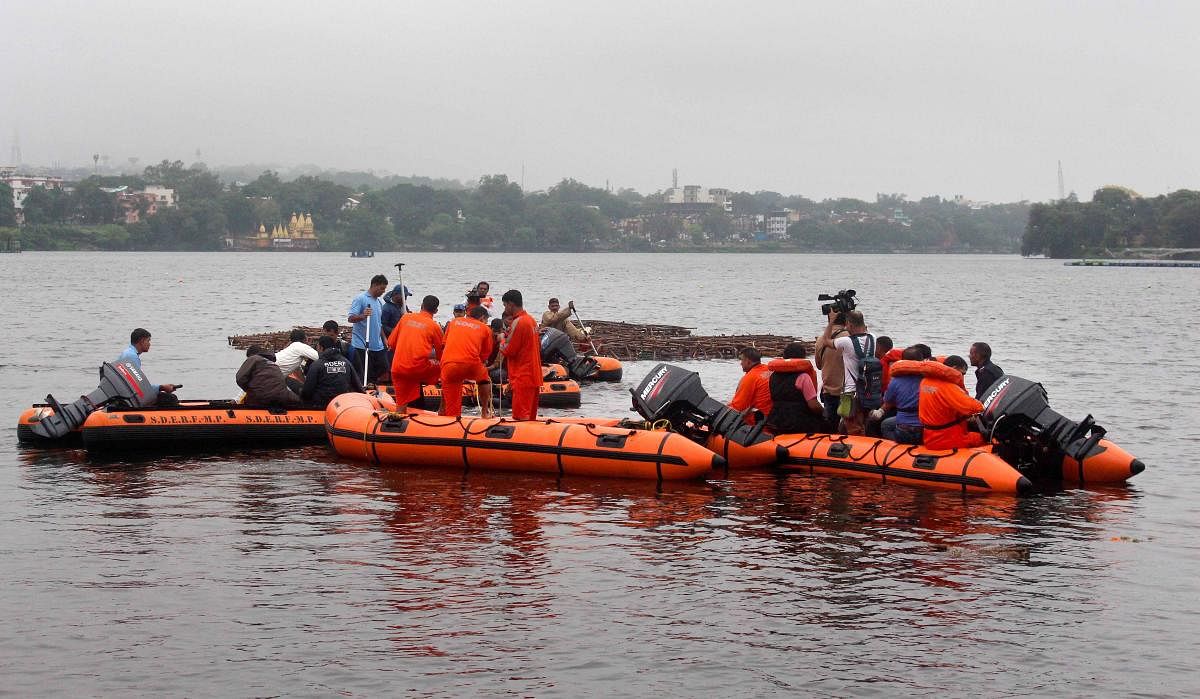 State Disaster Emergency Response Force (SDERF) personnel during a search and rescue operation after a boat capsized in the Lower Lake, in Bhopal. (PTI Photo)