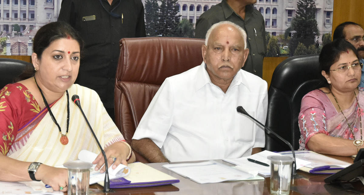 Union Minister for Women and Child Development and Textiles Smriti Irani, Chief Minister B S Yediyurappa and Minister of Women, Child Development and Empowerment of Differently Abled, Senior Citizens Shashikala Jolle during a meeting at the chief minister’s home office Krishna in Bengaluru on Friday. DH Photo
