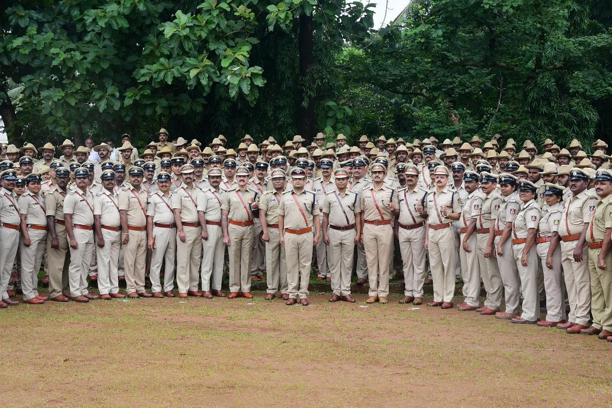 Commissioner of Police Dr P S Harsha along with police personnel and officers took part in the police service parade at CAR Ground in Mangaluru on Friday. DH Photo