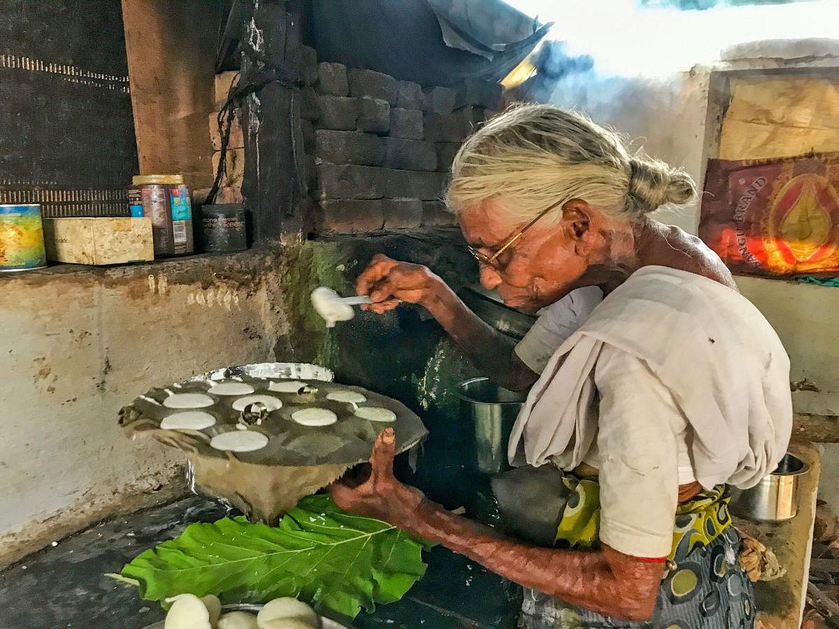 85-year old Kamalathal prepares idlis, a staple south Indian breakfast delicacy, in Coimbatore, Friday, Sept. 13, 2019. (PTI Photo)